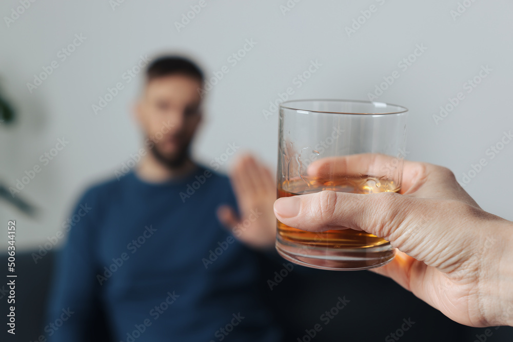 Man refusing to drink whiskey indoors, closeup. Alcohol addiction treatment Man refusing to drink whiskey indoors, closeup. Alcohol addiction treatment