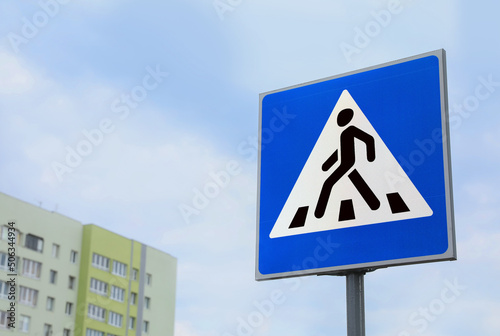 Traffic sign Pedestrian Crossing against cloudy sky, space for text