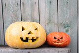 Halloween pumpkins heads on wooden background with free space