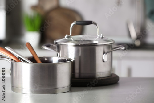 Cookware and kitchen utensils on grey table