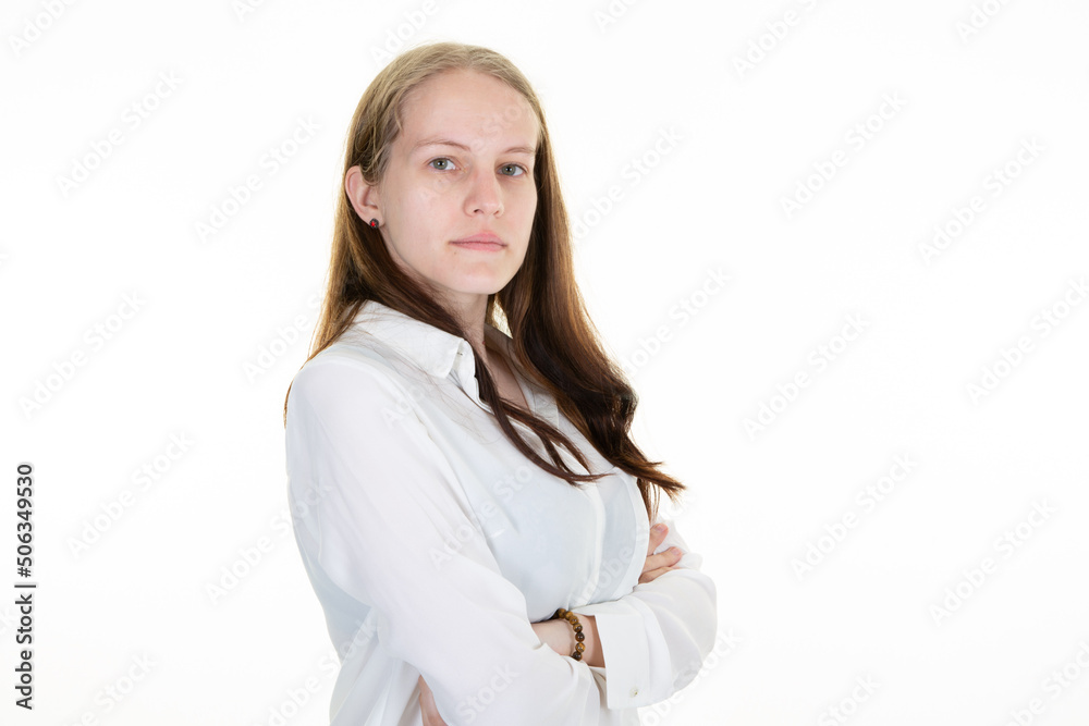 Young blonde woman over isolated white background keeping the arms crossed in side view Young blonde woman over isolated white background keeping the arms crossed in side view