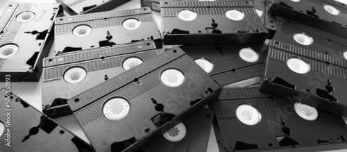 Messy stack of VHS tapes. Video Home System tape cassettes.