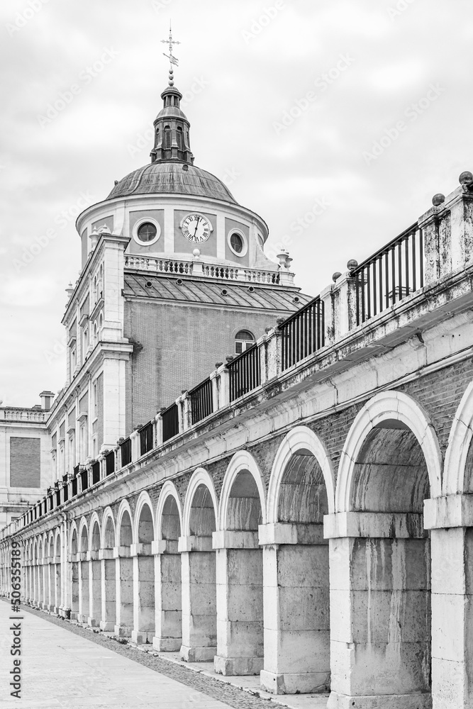 Royal Palace of Aranjuez. Begun to build in the 16th century, considered an asset of cultural interest. Detail of the arcades. Black and white. Vertical view.