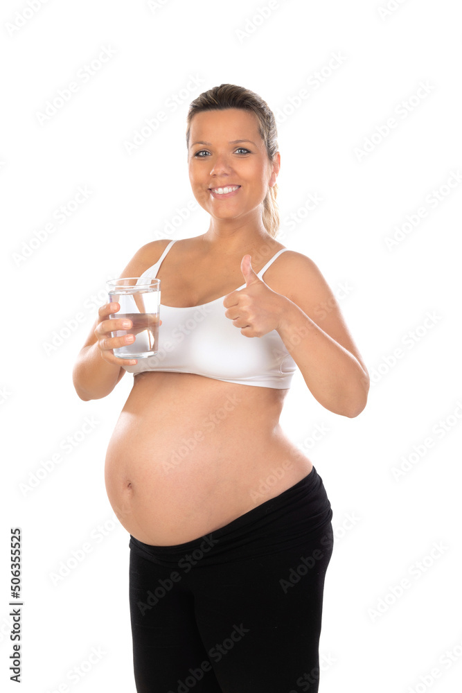 Beautiful smiling woman with a water glass waiting for baby Beautiful smiling woman with a water glass waiting for baby