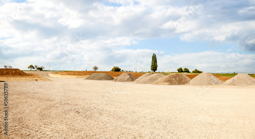 entrance construction site, driveway of building site. Pile of sand and Gravel for construction. limestone materials for construction industry.