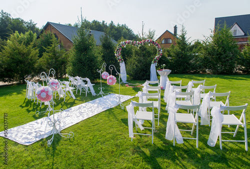 Prepared place with decorated chairs for the wedding ceremony