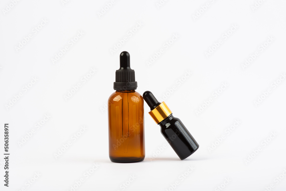 two bottles of facial oil on a white background two bottles of facial oil on a white background