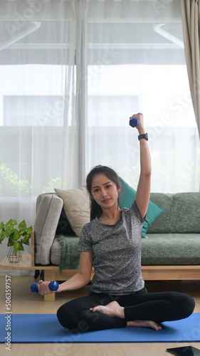 Free Download Full length photo of active young woman in sportswear exercising with dumbbells during fitness workout at home - GFXLoad