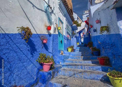 Traditional old blue street with color pots inside Medina of Chefchaouen, Morocco © Kokhanchikov