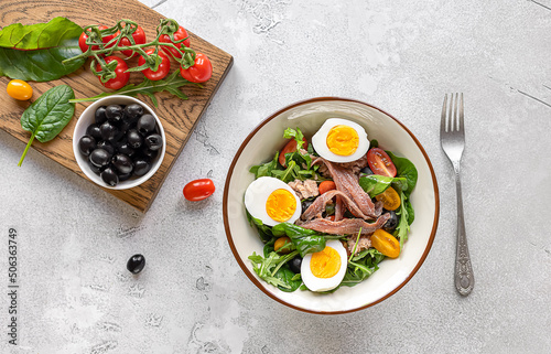 French composed salad with tuna, anchovy, hard-boiled eggs, tomatoes, and black olives.