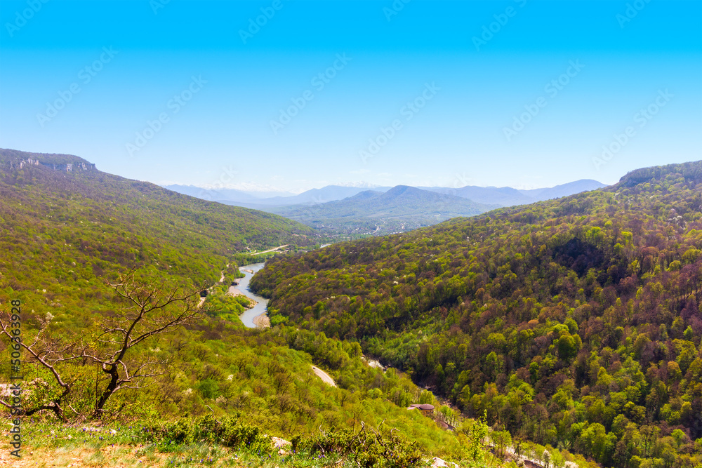 Obraz premium spring landscape with a view of forest hills and a river in the foothills of the Caucasus