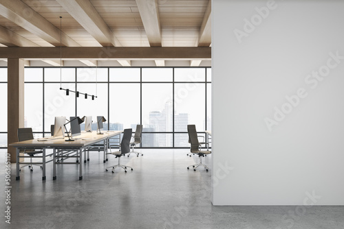 Front view on blank grey wall in light eco style office with stylish workspaces  modern computers  glossy concrete floor  wooden ceiling and city view from big window. 3D rendering  mock up