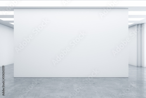 Fototapeta Naklejka Na Ścianę i Meble -  Big blank white wall part on concrete floor in empty light abstract hall with minimalistic interior design. 3D rendering, mock up