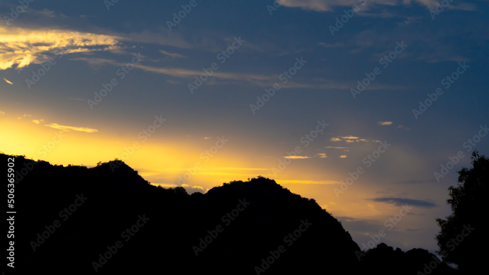 sky sunset light(gold) clouds, and mountain silhouette, copy space and abstract