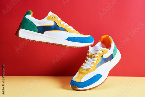 Flying trendy sneakers on creative colorful background, Stylish fashionable minimalism concept, Levitation shoes