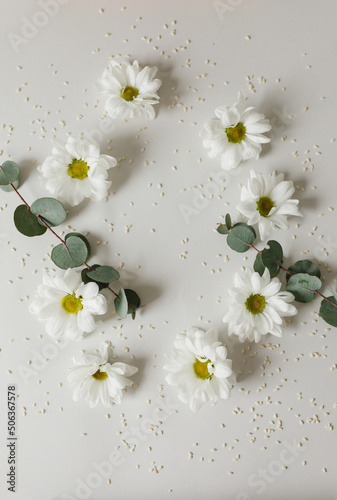 Layout of flowers and greenery on a gray background. Flatlay.