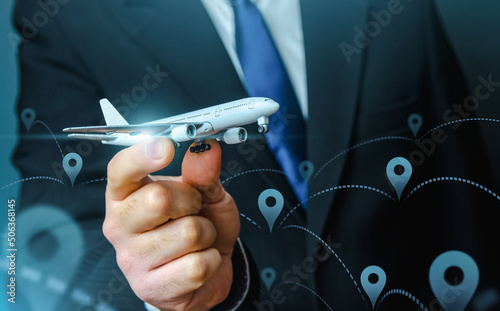 Passenger plane in businessmans hand. Commercial flight management and set new directions. Low cost travel flights. Air traffic communication. Delivery Services. Business trips and tourism. Air miles