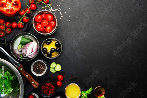 Vegetables, olives, oil and ingredients for cooking Greek salad with feta cheese, cherry tomato, paprika, cucumber and red onion, healthy vegetarian Mediterranean diet food, low calories eating.