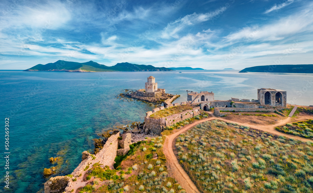 Picturesque summer view from flying drone of old Methoni Castle. Aerial seascape of Ionian sea. Beautiful outdoor scene of Peloponnese peninsula, Greece, Europe. Traveling concept background.