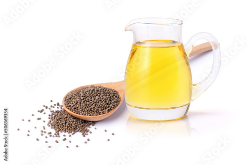 Obraz na płótnie Perilla flutescens seeds in wooden spoon and perilla seed oil in glass jar isolated on white background