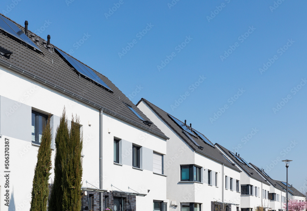 Germany, North Rhine-Westphalia, Cologne, Row of identical houses in modern suburb Germany, North Rhine-Westphalia, Cologne, Row of identical houses in modern suburb