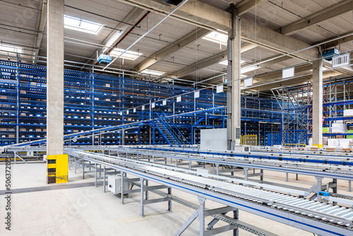 Empty conveyor belt in warehouse photo