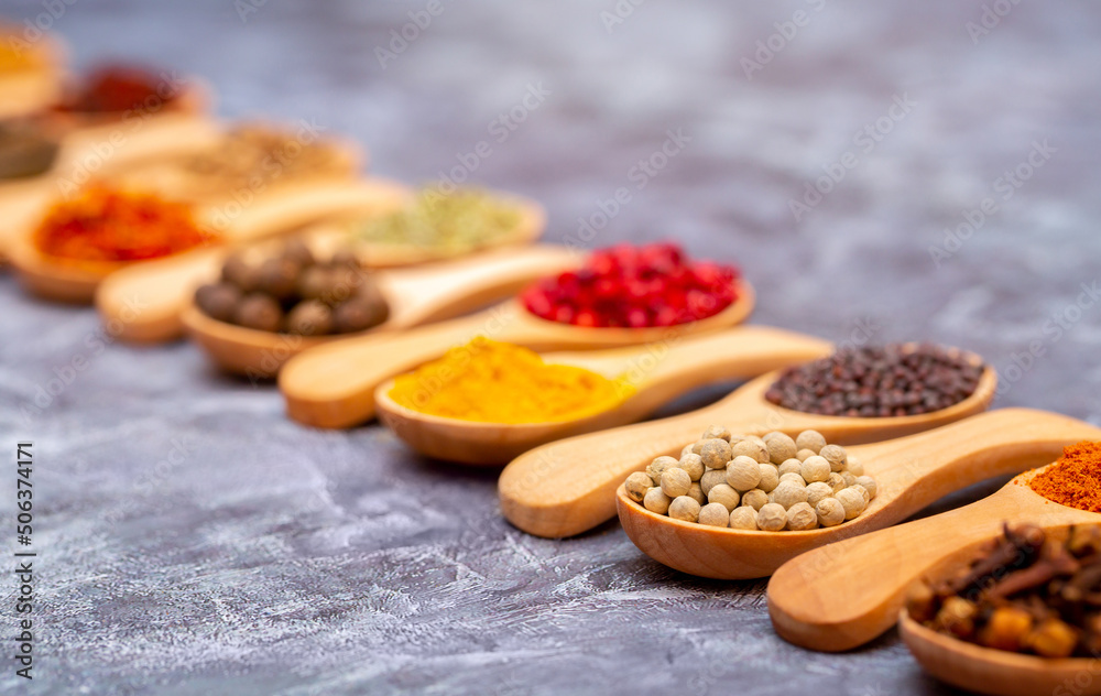 A set of spices on a gray background. Variety of spices from India. Food decoration design. Various spices, peppers and herbs close-up top view. Set of peppers, salt, herbs and spices for cooking. A set of spices on a gray background. Variety of spices from India. Food decoration design. Various spices, peppers and herbs close-up top view. Set of peppers, salt, herbs and spices for cooking.
