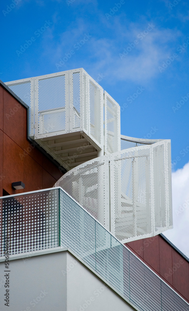 Fototapeta premium Architectural details of modern apartment building. Exterior staircase view.