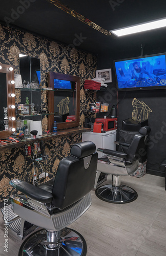 Empty black chairs and mirrors in barber shop