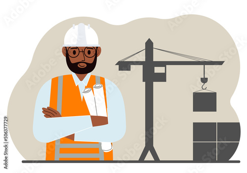 Happy engineer near the construction crane. Builder holding blueprints near construction machinery.