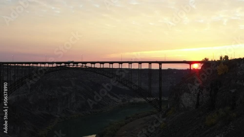 Wallpaper Mural Drone clip revealing the morning sun below a bridge during sunrise with orange skies through the deep valley and gorge Torontodigital.ca