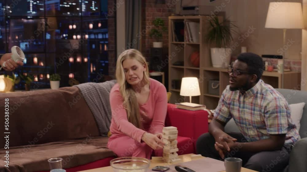 Television Sitcom Concept: Four Friends have Fun in Living Room. Funny Sketch About Two Couples. Guy in VR Headset has Metaverse Addiction. Comedy Series Broadcast Network Channel, Streaming Service Television Sitcom Concept: Four Friends have Fun in Living Room. Funny Sketch About Two Couples. Guy in VR Headset has Metaverse Addiction. Comedy Series Broadcast Network Channel, Streaming Service
