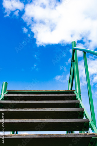 staircase with wooden steps looking up to the sky (Corrected)