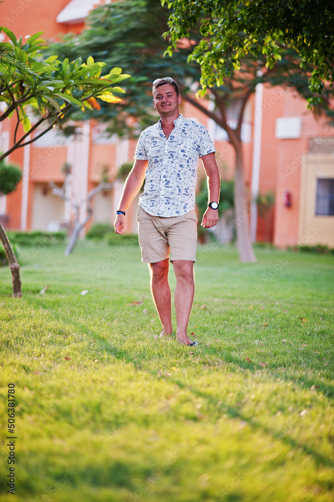 Fototapeta premium Young man at garden of egyptian resort.