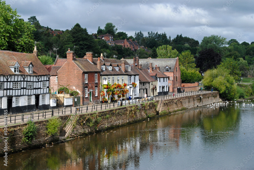View of Old Houses and Street Reflected in Calm Waters of River View of Old Houses and Street Reflected in Calm Waters of River