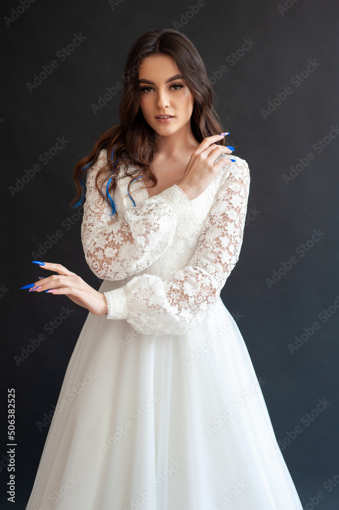 Full length bride portrait. Elegant woman in white wedding dress spinning in beige interior. Full length bride portrait. Elegant woman in white wedding dress spinning in beige interior.