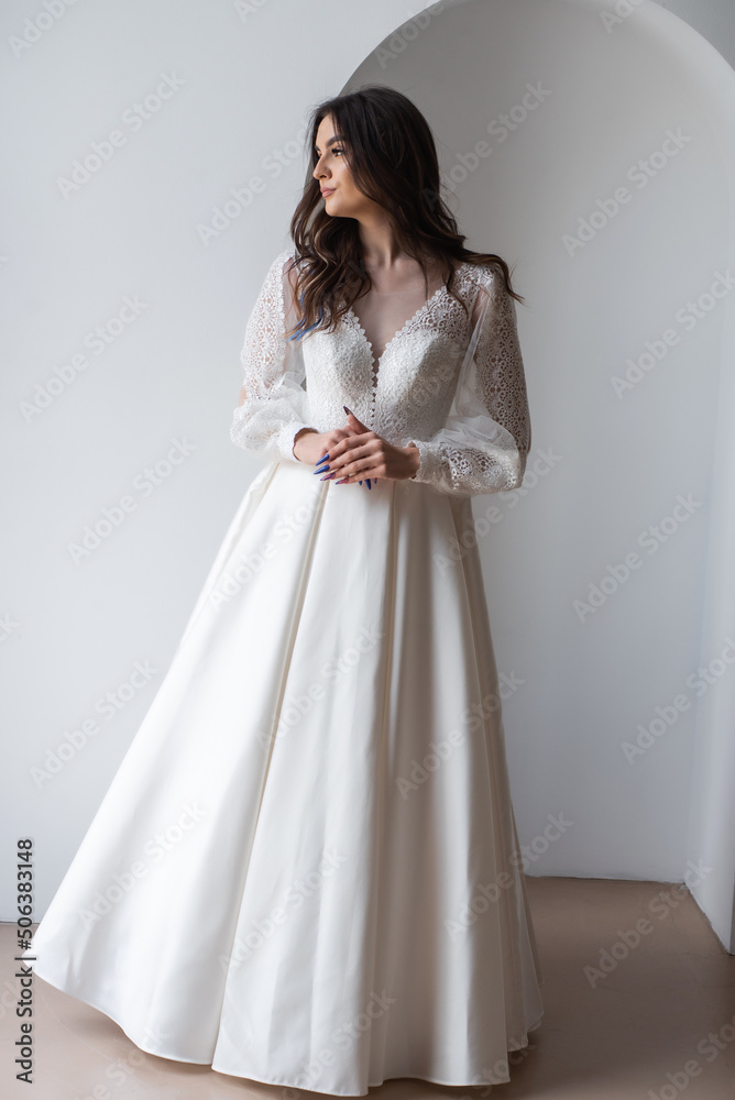 Beauty Portrait of bride wearing in wedding dress with voluminous skirt, studio photo. Young attractive bride. Smiling beautiful young bride Beauty Portrait of bride wearing in wedding dress with voluminous skirt, studio photo. Young attractive bride. Smiling beautiful young bride