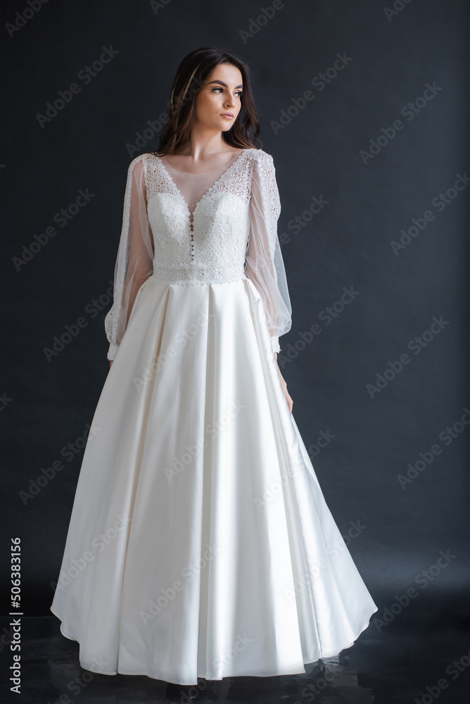 The beautiful woman posing in a wedding dress