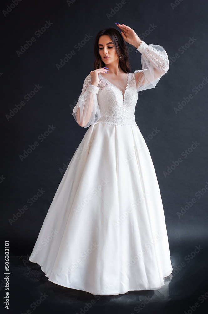 Beauty Portrait of bride wearing in wedding dress with voluminous skirt, studio photo. Young attractive bride. Smiling beautiful young bride