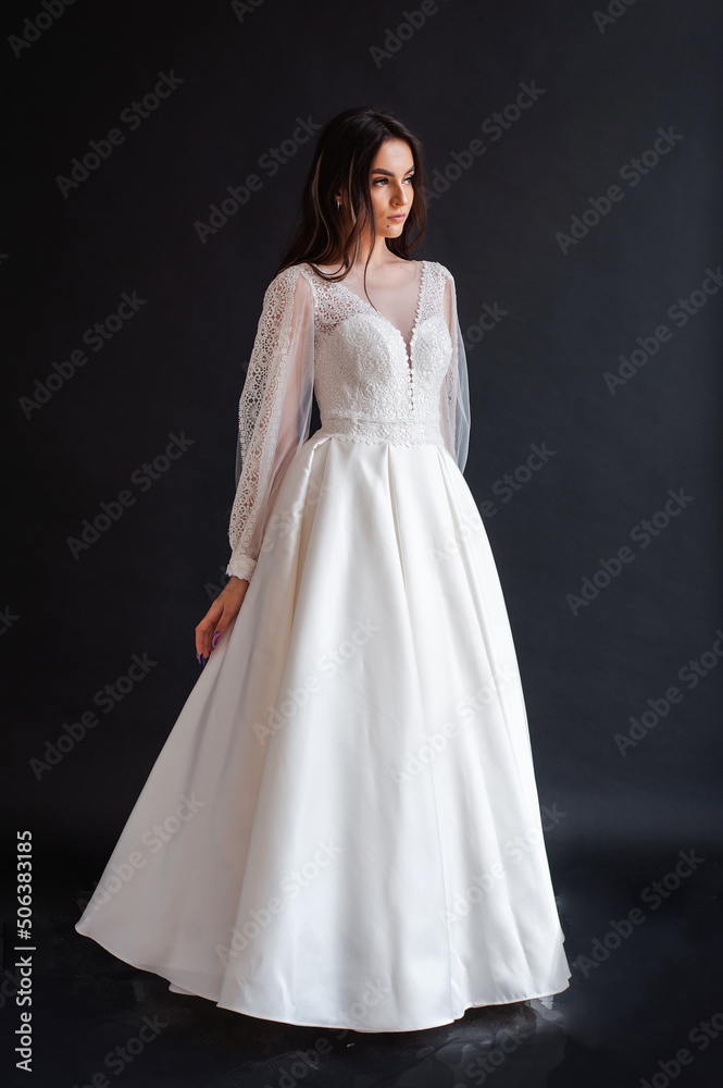 The beautiful woman posing in a wedding dress