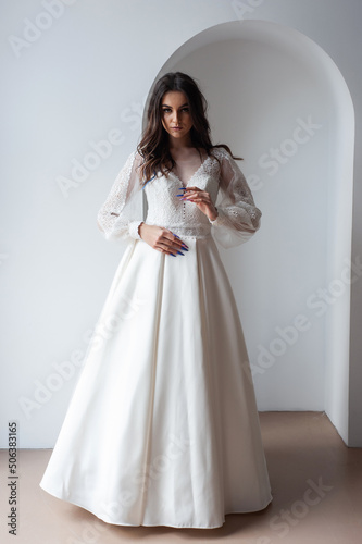 Beauty Portrait of bride wearing in wedding dress with voluminous skirt  studio photo. Young attractive bride. Smiling beautiful young bride