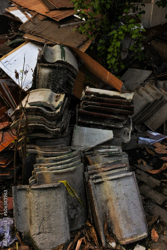 roofs of house, tiles that have been damaged and various building materials that are arranged and are no longer used