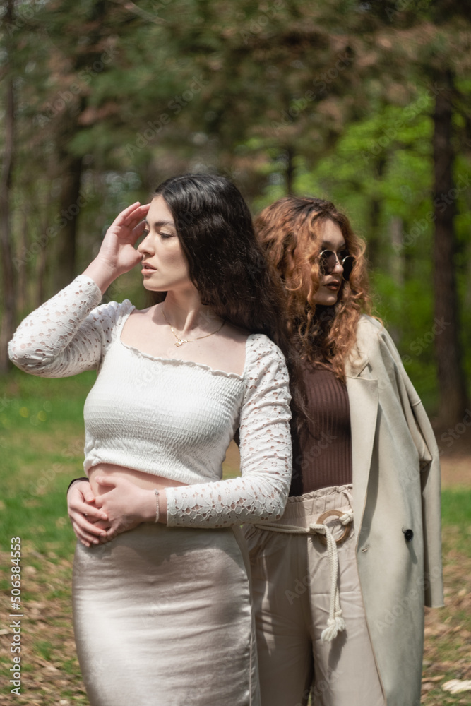 Two attractive girlfriends portrait in the forest Two attractive girlfriends portrait in the forest