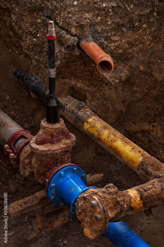 Installing new water pipes.
Water  pipes  in a trench at a construction site. Close-up.
