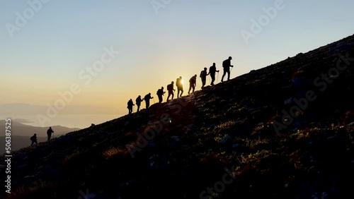 harmonious, regular and disciplined mountaineering walk of professional mountaineers photo