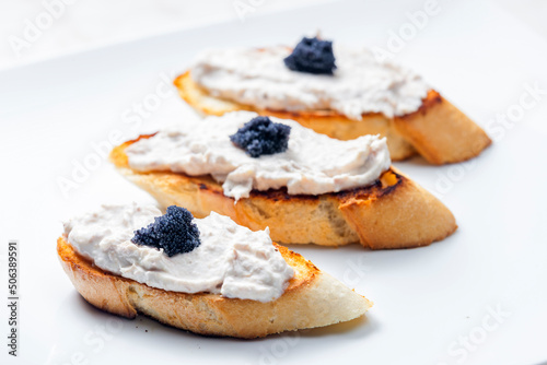 toasted baguette with tuna spread and black caviar