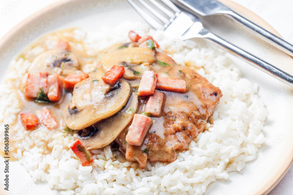 pork fillet with mushroom sauce and ham served with white rice pork fillet with mushroom sauce and ham served with white rice