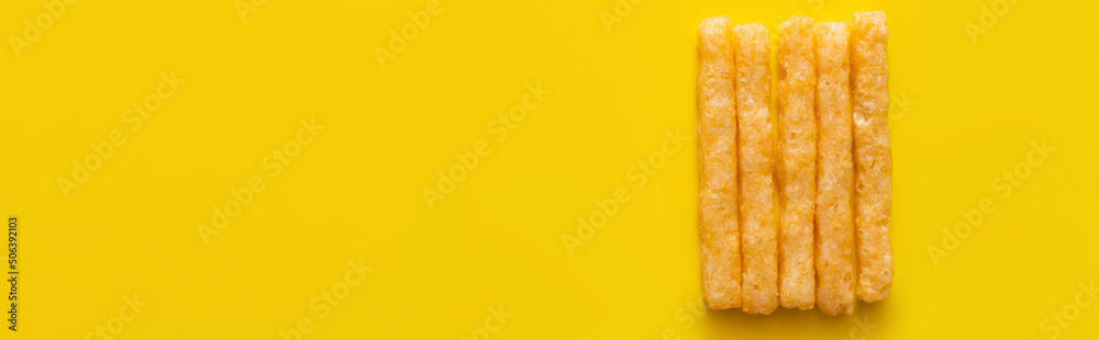 flat lay of delicious and crispy french fries on yellow, banner - obrazy, fototapety, plakaty 