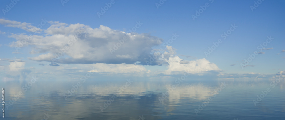 sky and water. a calm landscape of clouds reflecting in the water