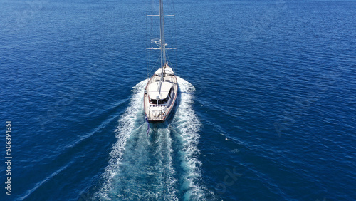 Wallpaper Mural Aerial drone birds eye view photo of beautiful sailboat with blue sails cruising in the deep blue Aegean sea, Greece Torontodigital.ca
